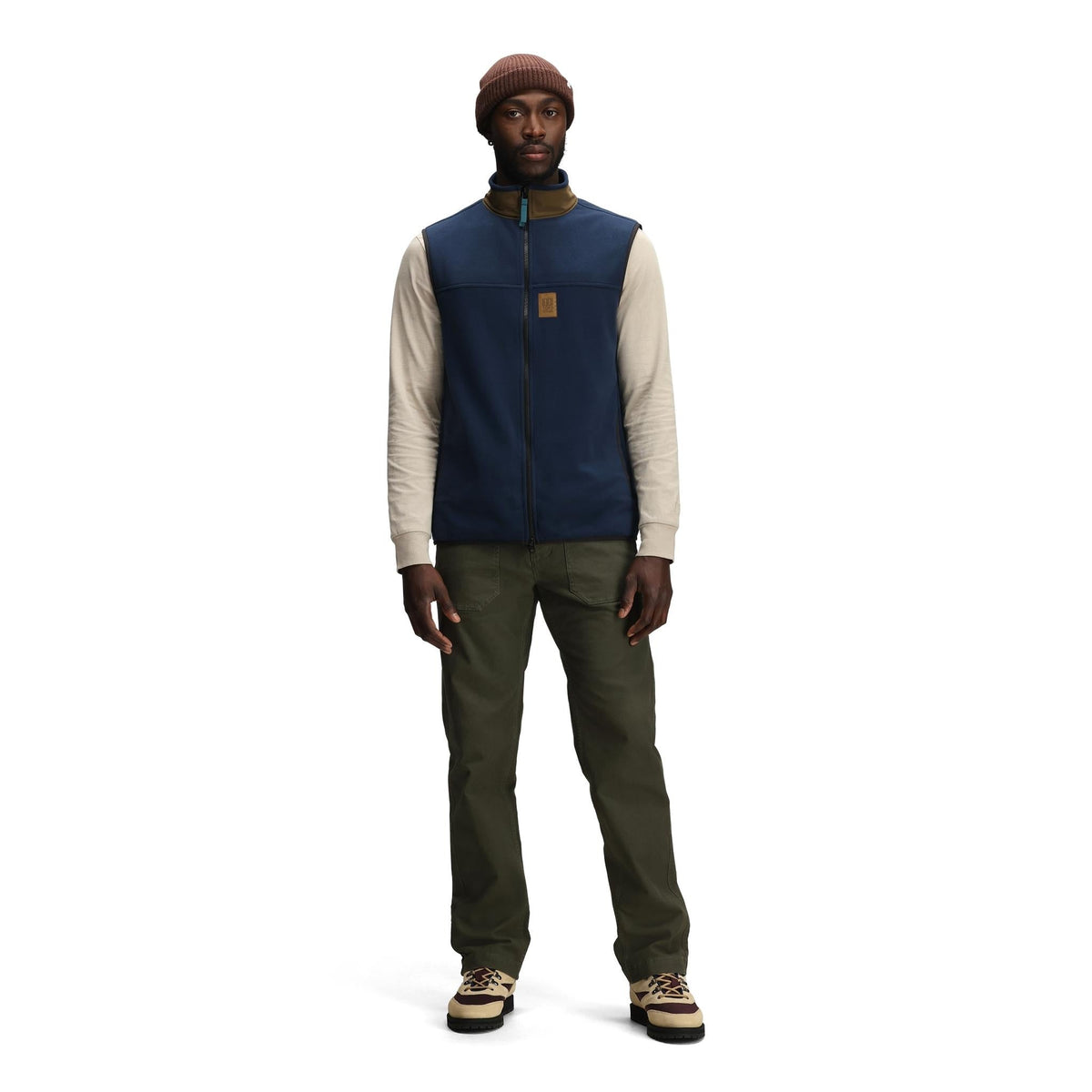 General front model shot of Topo Designs Vista Lightweight Fleece Vest - Men's in "Midnight / Desert Palm"
