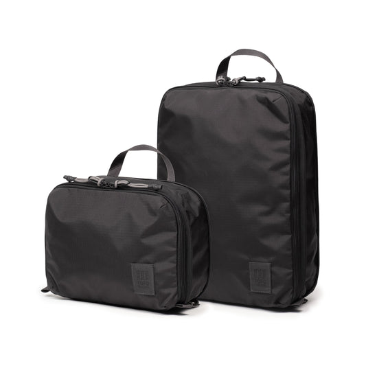 Front quarter white background image of Topo Designs Global Compression Pack Bag Set in "Black / Black"